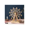 A wooden model of a Ferris wheel is displayed on a pink surface against a dark blue background. Náhled obrázku produktu