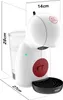 A white coffee machine with red accents and a glass of water next to it, showing dimensions. Produktbild-Vorschau