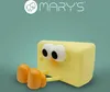 A cartoon-like cheese-shaped night light with large eyes and orange legs sits against a teal background. The brand logo 'MARY'S' is visible at the top. Podgląd zdjęcia produktu