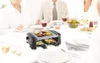 A group of people are gathered around a table, with a mini raclette grill in the center. Produktbild-Vorschau