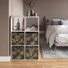 A bedroom setting with a storage cube and a bed. Náhled obrázku produktu