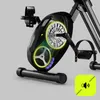 A close-up view of the internal mechanism of a black exercise bike, highlighting the flywheel and belt system with glowing accents. Anteprima dell’immagine prodotto