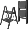 A black foldable step stool is shown in two configurations: one unfolded with two steps, and one folded. Náhled obrázku produktu
