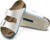 A pair of white Birkenstock Arizona sandals shown from a diagonal angle on a white background. Náhľad obrázku produktu