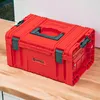 A red tool box sits on a wooden surface. Anteprima dell’immagine prodotto