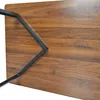 Close-up view of the underside of a wooden table with black metal legs. Podgląd zdjęcia produktu