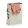 A beige laundry basket with a pink towel inside, set against a white background. Anteprima dell’immagine prodotto