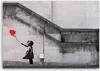 A stencil artwork on a stone wall depicting a girl releasing a red heart-shaped balloon, with text above. Podgląd zdjęcia produktu