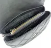 A close-up view of the interior of a black quilted handbag, showing the main compartment and a zippered pocket. Anteprima dell’immagine prodotto