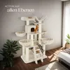A multi-level cat tree with two cats, one orange and one tabby, playing on it. The cat tree is in a room with a gray wall and wooden floor, with a plant and a bed visible in the background. Náhled obrázku produktu