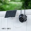 A black security camera with a solar panel attached to a white wall during a rain shower. Náhled obrázku produktu