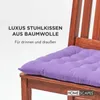 A close-up of a purple seat cushion on a wooden chair. Náhled obrázku produktu