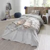 A bedroom scene with a bed made up with bedding featuring owls in a snowy setting. Produktbild-Vorschau