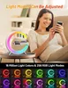A woman is using her phone while a colorful lamp with a wireless charger is on a table. Produktbild-Vorschau