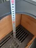A close-up view of a measuring tape inside a stove or oven. Produktbild-Vorschau