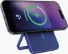 A smartphone is charging wirelessly on a blue charging stand. Produktbild-Vorschau