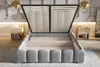 A bed with its storage compartment open, showing the slatted base and the interior storage space. Two bedside tables are visible on either side of the bed. Produktbild-Vorschau