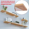 Three wooden shelves are mounted on a light gray wall, with various decorative items and books placed on them. A close-up inset shows a white triangular bracket supporting a shelf. Produktbild-Vorschau