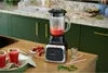 A blender with strawberry smoothie in a kitchen setting. Produktbild-Vorschau