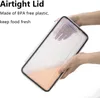 Hands holding a clear plastic food storage container with an orange liquid inside. Produktbild-Vorschau