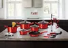 A collection of red cookware and a knife set arranged on a kitchen countertop. Produktbild-Vorschau