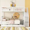 A white bunk bed with drawers, decorated with stuffed animals and children's artwork. Náhled obrázku produktu