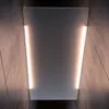 A modern, minimalist light fixture mounted on a textured wall. Produktbild-Vorschau