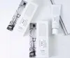A flat lay of two boxes and a tube of cream, all with minimalist branding. Podgląd zdjęcia produktu