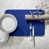 A table setting with plates, cutlery, and a placemat. Produktbild-Vorschau
