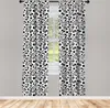 Two curtains with a repeating pattern of soccer balls hang in front of a window. Produktbild-Vorschau