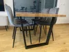 A dining table with chairs in a room. Anteprima dell’immagine prodotto