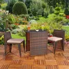 A garden furniture set with two chairs and a table is placed on a wooden deck in a lush garden setting. Anteprima dell’immagine prodotto