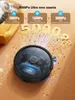 A robotic vacuum cleaner is shown on a wooden floor, with a cat in the background. Text overlays highlight suction power levels and features. The vacuum is depicted cleaning up debris. Podgląd zdjęcia produktu