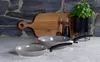 Kitchen counter with cookware, cutting board, and basil plant. Produktbild-Vorschau