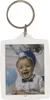 A baby wearing a party hat and a bow tie, in front of balloons. Produktbild-Vorschau
