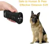A hand holds a black anti-bark device, with a German Shepherd dog sitting in front of it. Podgląd zdjęcia produktu