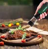 A hand holding a pepper grinder over a plate of grilled ribs, with tomatoes and rosemary as garnish. Produktbild-Vorschau