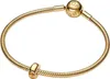 A close-up studio shot of a gold-plated Pandora Moments charm clip bracelet on a white background. Podgląd zdjęcia produktu