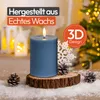 A blue LED candle with a flame sits on a wooden base, surrounded by snow and pinecones, with a Christmas tree and lanterns in the background. Voir les images du produit