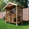 A wooden log store filled with firewood, situated on a green lawn in front of a wooden fence and trees. Produktbild-Vorschau