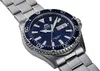 A close-up shot of a men's wristwatch with a blue dial and silver metal band, set against a white background. Produktbild-Vorschau
