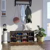 An entryway with a shoe cabinet, bench, coats, and an umbrella stand. Náhľad obrázku produktu