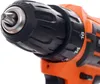 Close-up of the chuck and torque adjustment ring of an orange and black power drill. Anteprima dell’immagine prodotto
