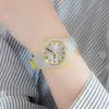 A person's arm wearing a watch. Voir les images du produit