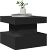 A black side table with books and a vase with greenery on top. Produktbild-Vorschau