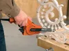 A person is using a Black & Decker power file to sand a decorative metal piece. Náhľad obrázku produktu