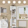 A white bathroom cabinet with open shelves and doors, placed next to a window with a radiator below. The cabinet is filled with toiletries and towels. Náhled obrázku produktu