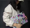 A person holding a tablet covered in stickers. Náhled obrázku produktu
