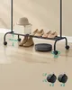 A rolling clothing rack with shoes, boots, a hat, and a box. Náhled obrázku produktu