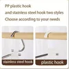 Collage showing two types of hangers: one with a stainless steel hook and another with a plastic hook, against a wooden rod. Anteprima dell’immagine prodotto